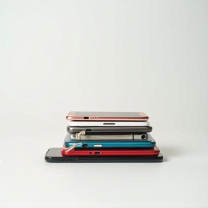 Stack of old and new smartphones, representing trade-in